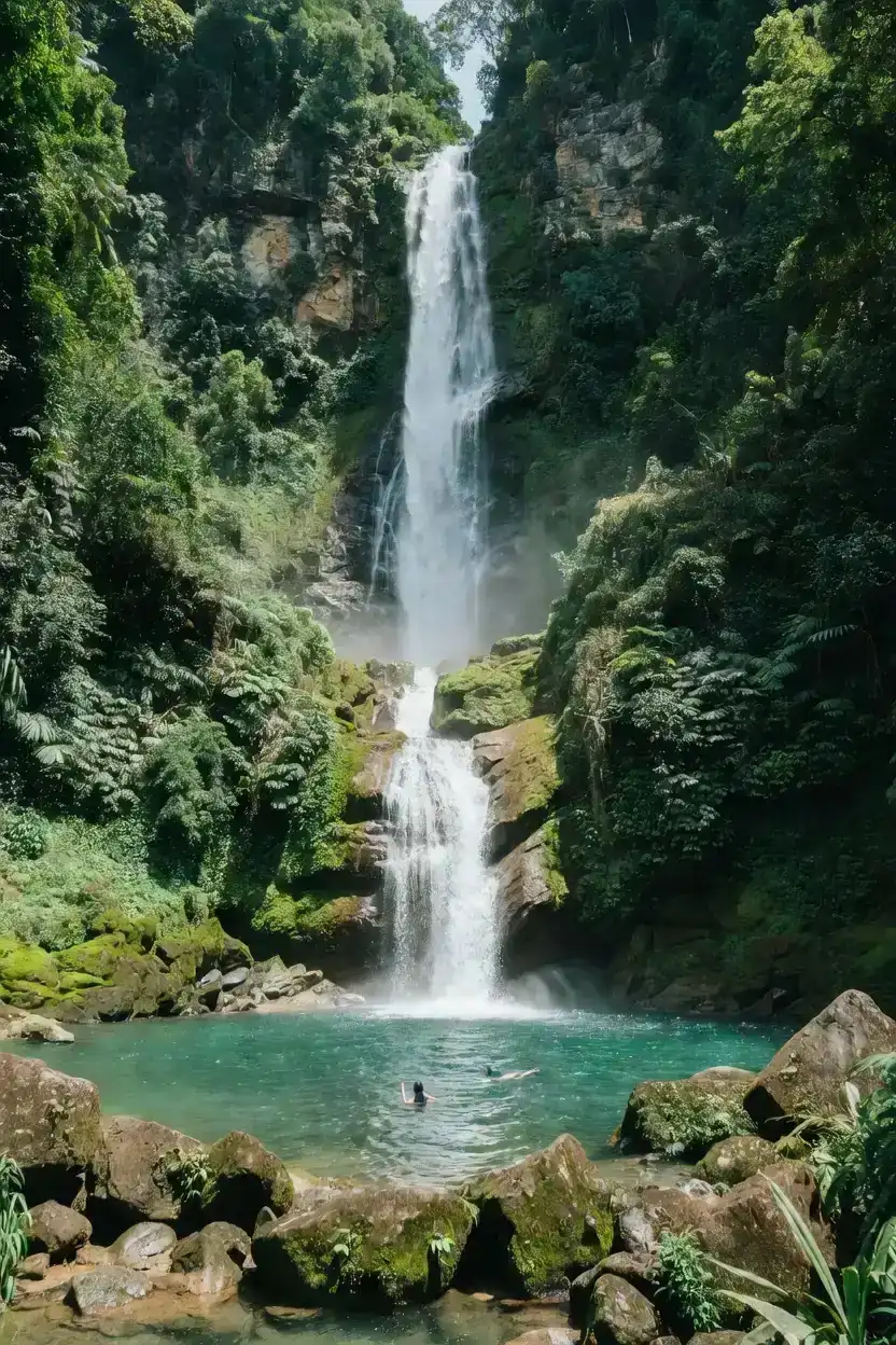 A tall Tamanique waterfall dropping into an emerald plunge pool deep in the El Bálsamo jungle on a Tamanique waterfalls tour, El Salvador